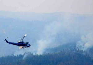 Helicopter flying over the forest fires